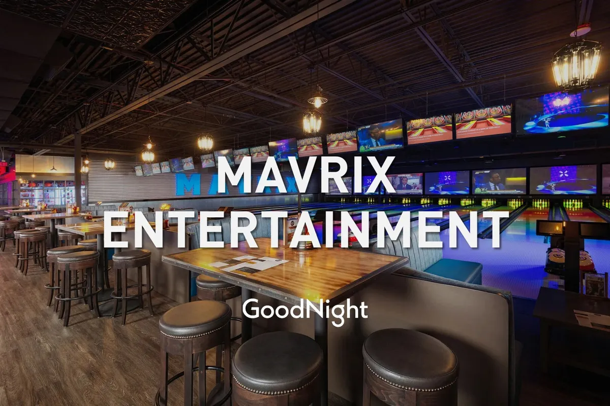 A vibrant interior scene at Mavrix Entertainment, highlighting bowling lanes, a bar area, and large television screens. The space is filled with playful energy, perfect for group activities and family celebrations.