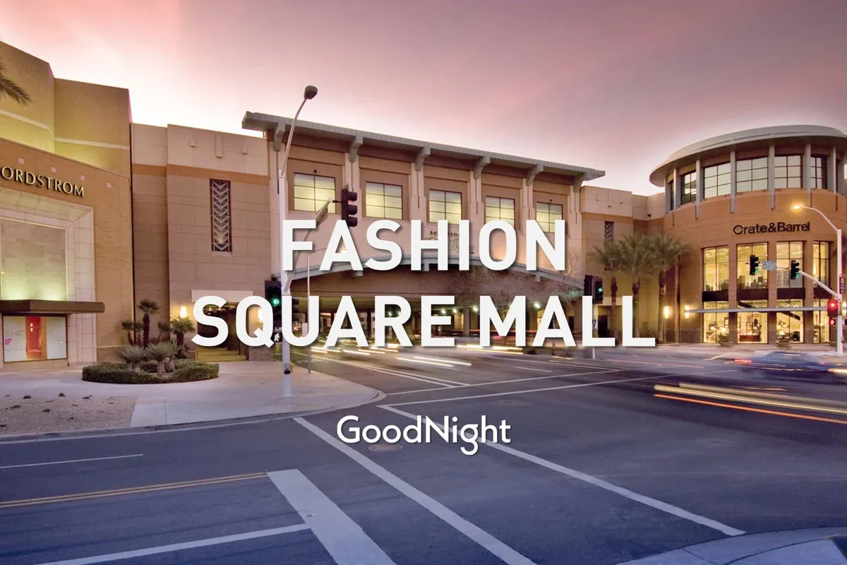 A lively street intersection featuring Nordstrom and Crate & Barrel storefronts, framed by palm trees and an energetic urban vibe. The scene hints at accessible shopping, dining, and the vibrant pulse of Old Town Scottsdale.