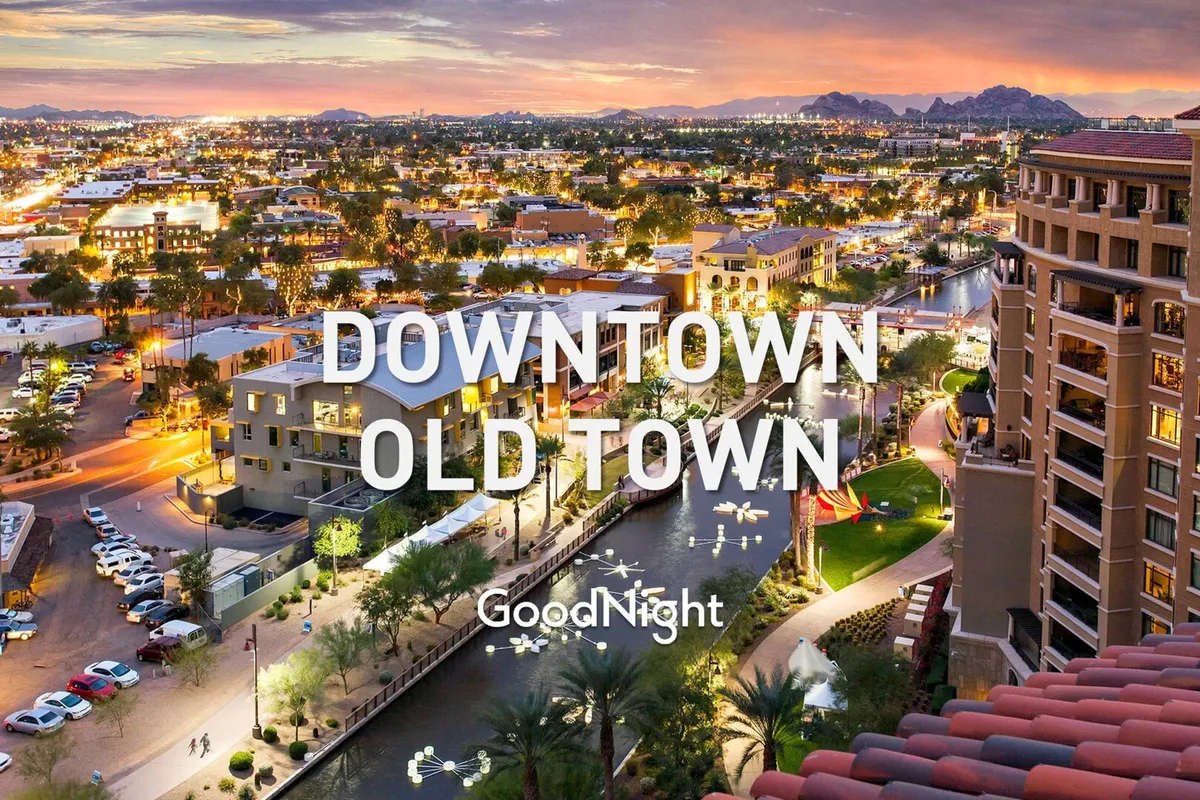 A dynamic view of downtown buildings, a river canal, mountains in the distance, and park areas bustling with activity. This lively scene represents the vibrant local context and the variety of nearby venues for dining, events, or team outings.